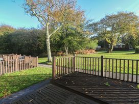 An outdoor area with a deck and trees at Little Egret - Number 2