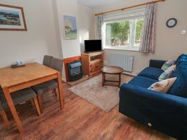 A living room with a dining area and television at Little Egret - Number 2