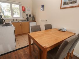 A kitchen with a dining table and chairs at Little Egret - Number 2