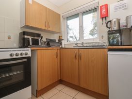 A kitchen with cabinets, sink, and appliances at Little Egret - Number 2