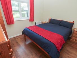 A bedroom with a bed and dresser at Little Egret - Number 2