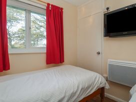 A bedroom with a bed and a TV at Little Egret - Number 2