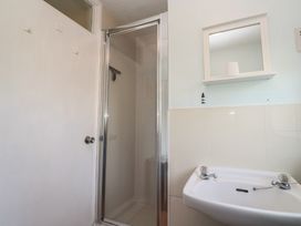 A bathroom with a shower and sink at Little Egret - Number 2