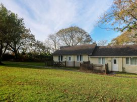 A house with a wooden fence and grass at Little Egret - Number 2
