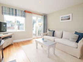 A living room with a sofa and coffee table at The Mizzen St Endellion near Port Isaac