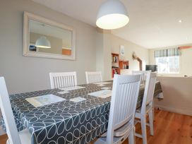 A dining room with a table and chairs at The Mizzen in St Endellion near Port Isaac