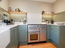 A kitchen with stove and various appliances at The Mizzen in St Endellion near Port Isaac