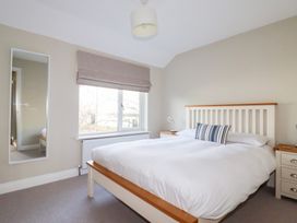 A bedroom with a bed and bedside table at The Mizzen St Endellion near Port Isaac