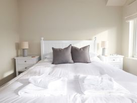 A bedroom with a bed and bedside tables at The Mizzen in St Endellion near Port Isaac