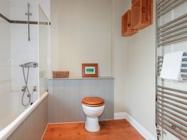 A bathroom featuring a bathtub, toilet, and towel rack at The Mizzen in St Endellion near Port Isaac