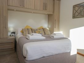 A bedroom with a bed and towels at Bluebell Lodge in Warton