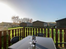 An outdoor area with a table and chairs at Bluebell Lodge in Warton
