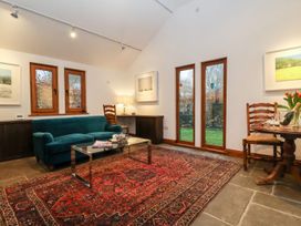 A living room with a sofa and coffee table at Owl Cottage in Woodbridge