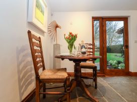 A dining room with a table and chairs at Owl Cottage in Woodbridge