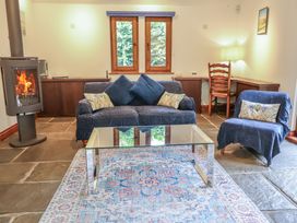 A living room with a sofa and coffee table at Owl Cottage in Kettleburgh near Framlingham