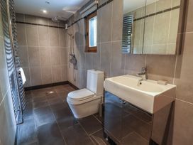A bathroom with a shower, toilet, and sink at Owl Cottage in Kettleburgh near Framlingham