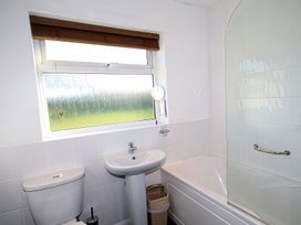 A bathroom with sink, toilet, and bathtub at Badgers Cliff in Polzeath