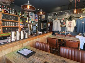 A bar with tables and stools at Chalet 86 in North Shields