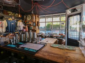 A cafe with a bar counter and clothing rack at Chalet 86 North Shields