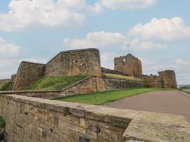 A castle with stone walls and a flag at Chalet 86 North Shields