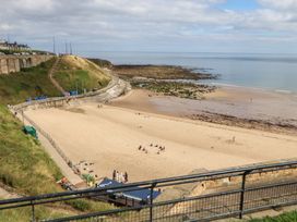 A beach with sand and ocean view at Chalet 86 in North Shields