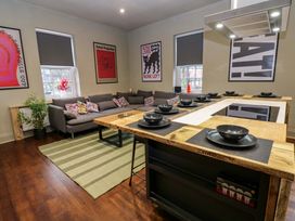 A kitchen island with bowls and a sofa in the living room at Chalet 86 Tynemouth