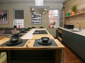 A kitchen with a central island and seating at Chalet 86 Tynemouth