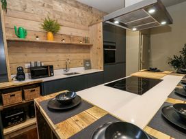 A kitchen with a countertop, sink, and kitchen appliances at Chalet 86 in Tynemouth