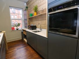 A kitchen with a sink and oven at Chalet 86 Tynemouth