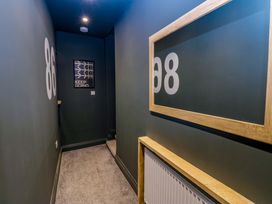 A hallway with framed numbers and a picture at Chalet 86 Tynemouth