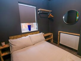 A bedroom with a bed and shelves at Chalet 86 Tynemouth