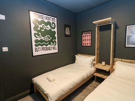 A bedroom with two beds and artwork on the wall at Chalet 86 Tynemouth