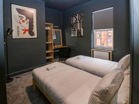 A bedroom with two beds and a desk at Chalet 86 in Tynemouth