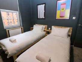 A bedroom with two beds and wall art at Chalet 86 in Tynemouth