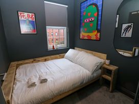 A bedroom with a bed and wall art at Chalet 86 in Tynemouth