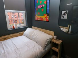 A bedroom with a bed and artwork on the wall at Chalet 86 in Tynemouth