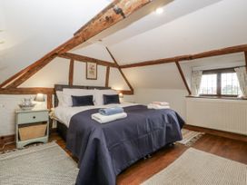 A bedroom with a bed and bedside table at Magpie Cottage in Worcester