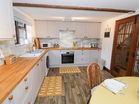 A kitchen with wooden counters and appliances at Magpie Cottage near Powick Callow End