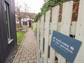 A pathway leading to a house with a sign at Magpie Cottage in Powick near Callow End