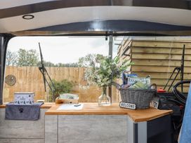A kitchen counter with flowers and a basket at The Bus on the Hill