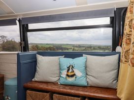 A snug with a bench and cushions at The Bus on the Hill
