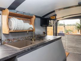A kitchen with a sink and dish rack at The Bus on the Hill
