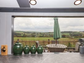 A kitchen with a window view of the countryside at The Bus on the Hill
