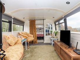 A snug with a couch and a television at The Bus on the Hill