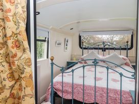 A bedroom with a bed and window at The Bus on the Hill