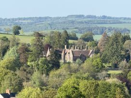 A mansion surrounded by trees and fields at The Bus on the Hill in Huntsham near Bampton, Devon
