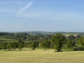 A landscape with fields and trees at The Bus on the Hill in Huntsham near Bampton, Devon