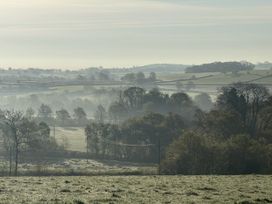A view of misty fields and trees at The Bus on the Hill in Huntsham near Bampton, Devon