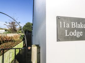 A sign on the wall indicating 11a Blake Lodge in Crantock