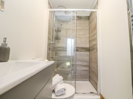 A bathroom with a shower and sink at Blake Lodge in Crantock